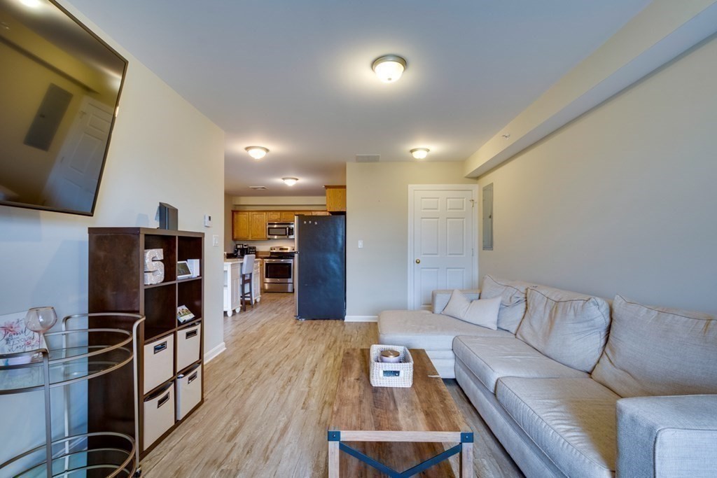 36 Webb Brook Road, Unit 4 Billerica, MA 01821 - Photo 10 of 21 a living room with furniture and a flat screen tv