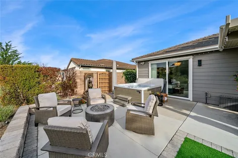 a view of a patio with table and chairs potted plants with floor to ceiling window and potted plants