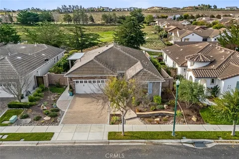 a living room with fireplace furniture and a large window