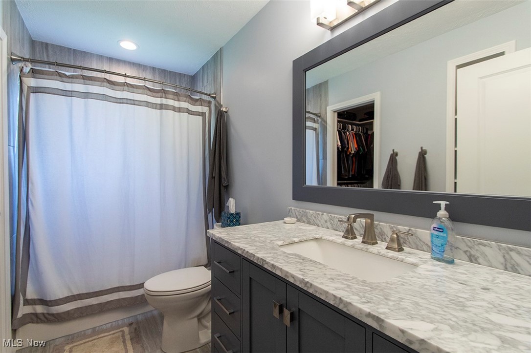 5859 Buffham Road Seville, OH 44273 - Photo 27 of 34 Bathroom featuring vanity, a shower with curtain, and a spacious closet