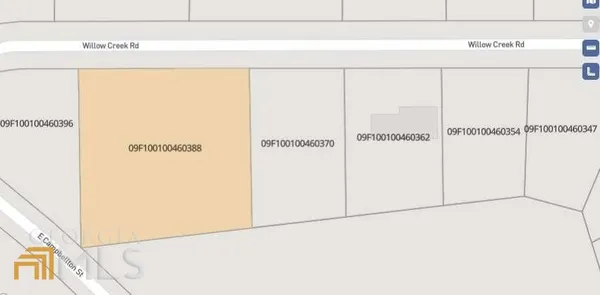 a sign broad in front of a tree