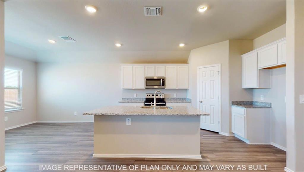 10325 Altair Drive Waco, TX 76708 - Photo 3 of 15 a view of a kitchen with kitchen island a sink stainless steel appliances and cabinets