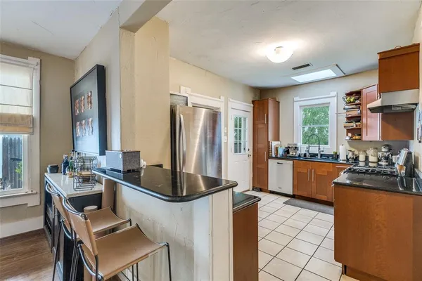 a kitchen with a refrigerator and a stove top oven