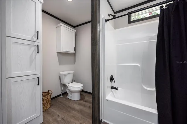 a bathroom with a toilet and a shower