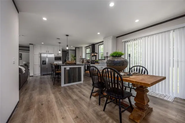 a dining room with furniture and wooden floor