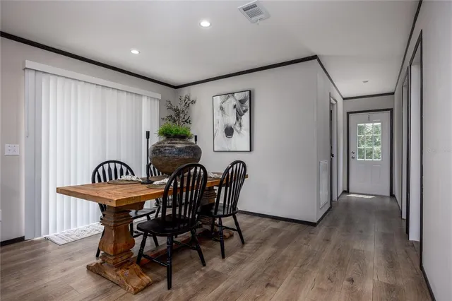 a view of a dining room with furniture window and wooden floor