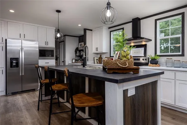 a kitchen with granite countertop a sink appliances and window