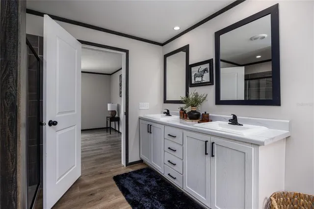 a spacious bathroom with a double vanity sink and a mirror