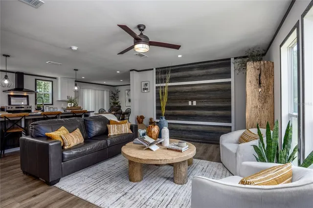 a living room with furniture and a potted plant