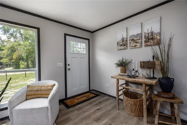 a view of a livingroom with furniture a flat screen tv and wooden floor