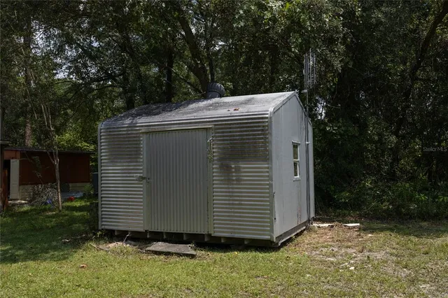 a view of house with backyard and garden