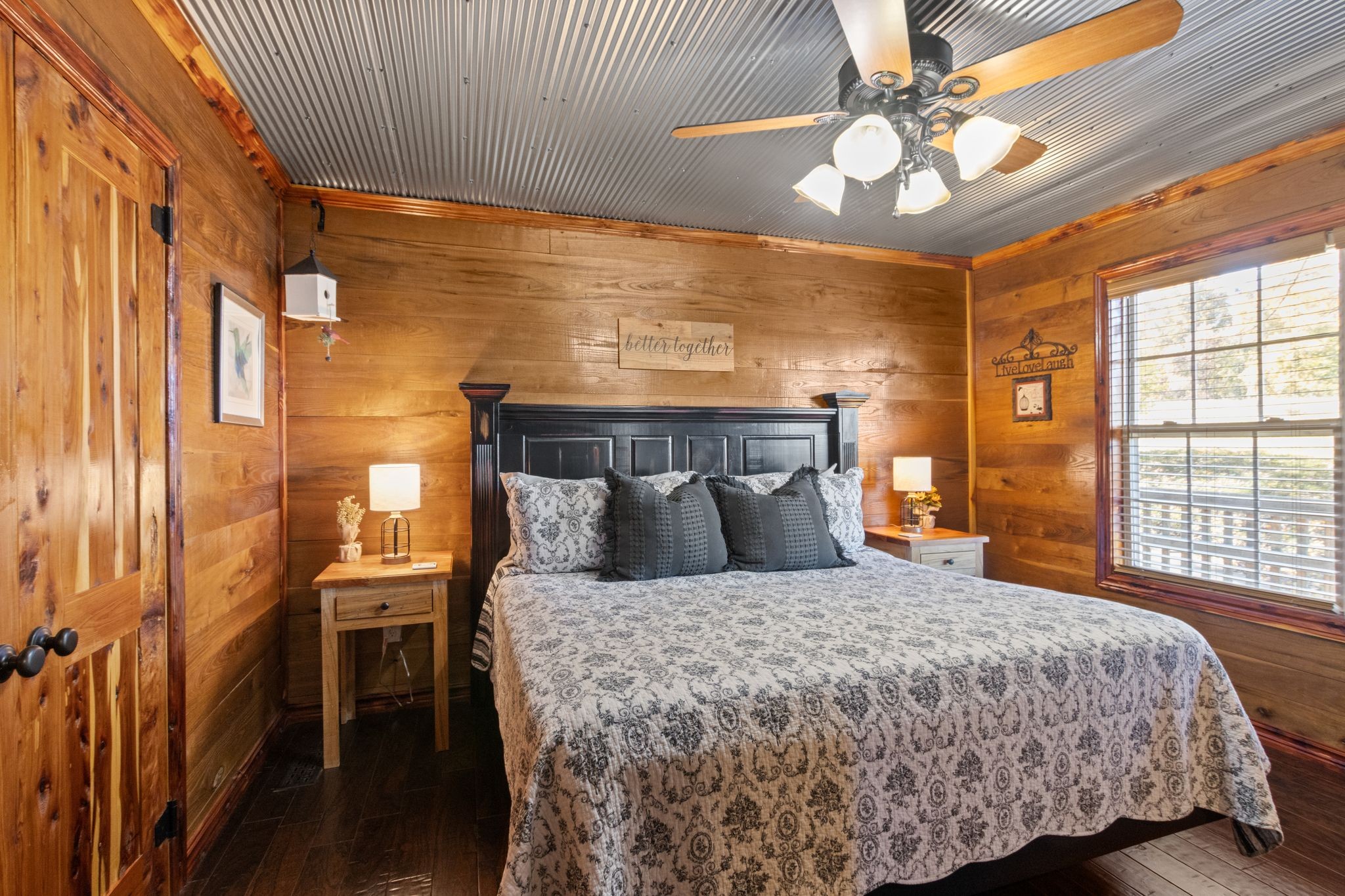 784 Damron Road Lynchburg, TN 37352 - Photo 12 of 38 a bedroom with a large bed and a chandelier