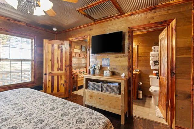 a view of a bedroom with wooden floor