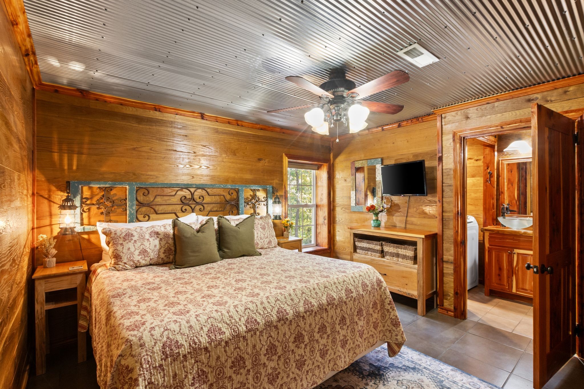 784 Damron Road Lynchburg, TN 37352 - Photo 28 of 38 a bedroom with a large bed and a flat tv screen