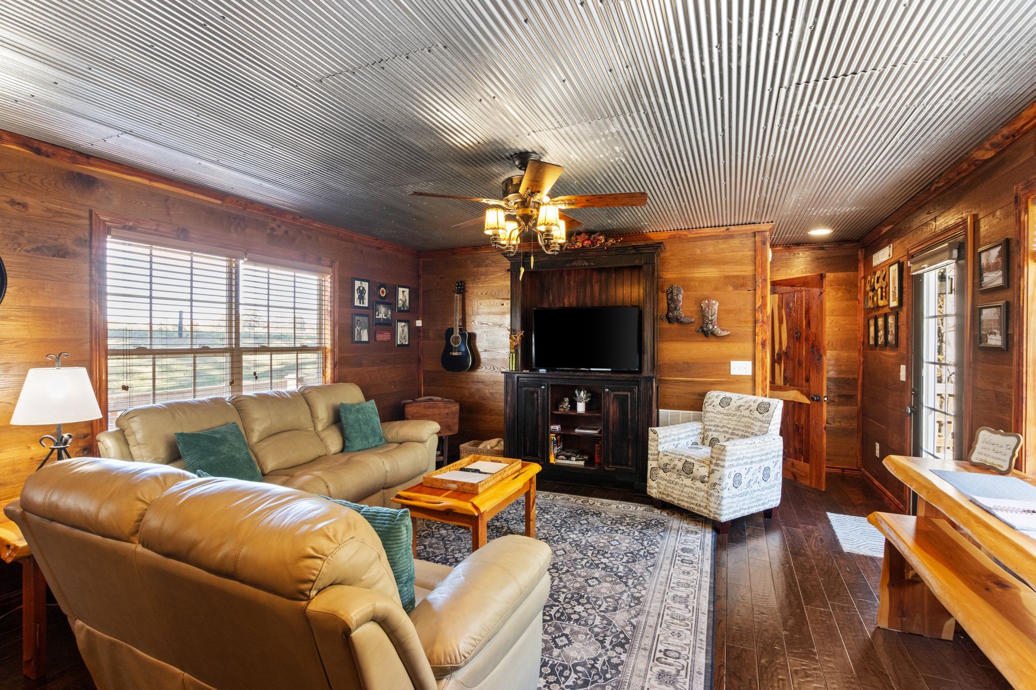 784 Damron Road Lynchburg, TN 37352 - Photo 9 of 38 a living room with furniture a flat screen tv and a fireplace