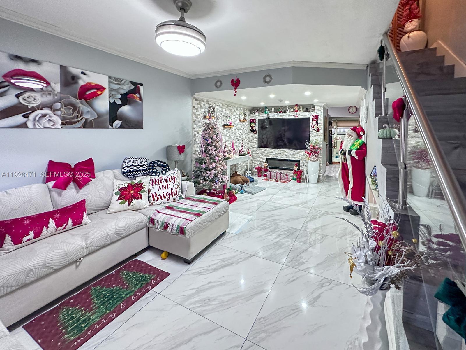 a living room with furniture and a flat screen tv