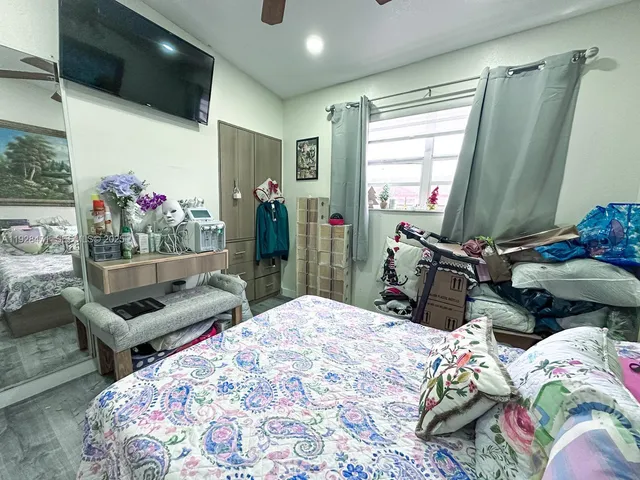 a bedroom with bed and a chandelier