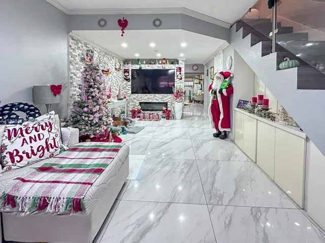 a living room filled with furniture and a potted plant