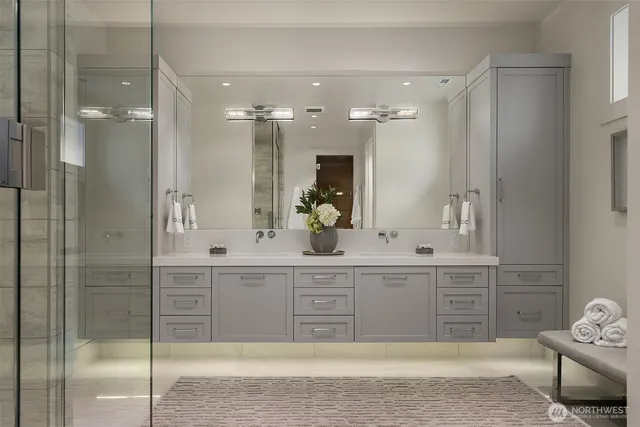 a spacious bathroom with a sink a shower and a mirror