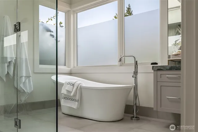 a bath tub sitting next to a shower