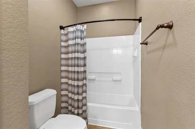 a bathroom with a shower and a toilet