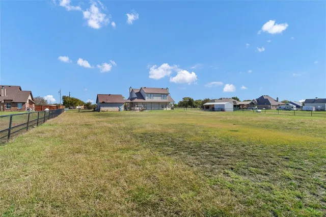 a view of a lake with outdoor seating and yard