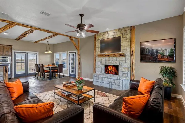 a living room with furniture a flat screen tv and a fireplace