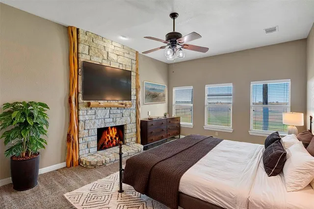 a bedroom with a bed and a fireplace