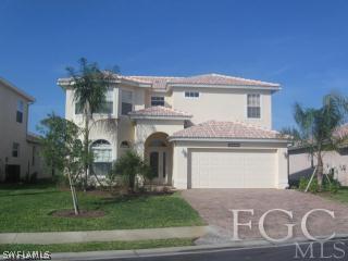 a front view of a house with a garden and garage