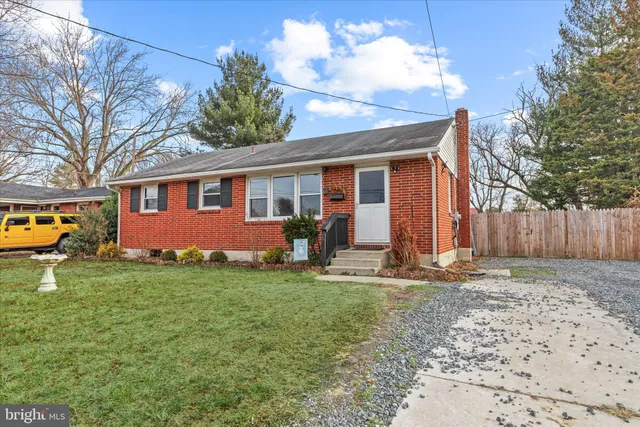 a backyard of a house with yard and outdoor seating