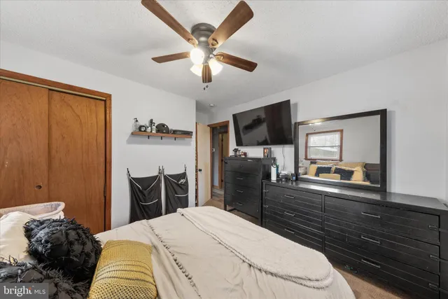 a bedroom with a bed and a large mirror with a flat tv screen