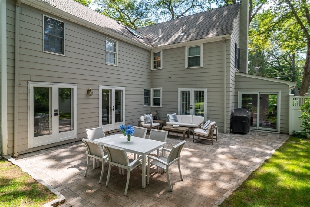 31 Martin Road Wellesley, MA 02481 - Photo 22 of 28 a backyard of a house with table and chairs
