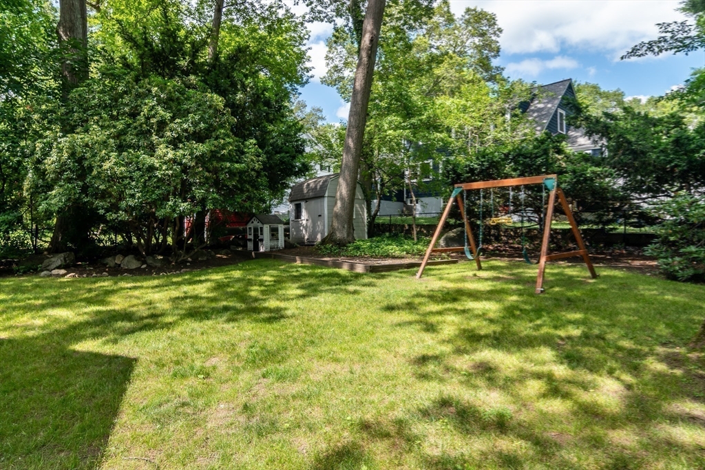 31 Martin Road Wellesley, MA 02481 - Photo 25 of 28 a backyard of a house with childrens swings and slides