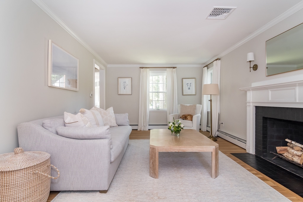 31 Martin Road Wellesley, MA 02481 - Photo 4 of 28 a living room with furniture and a fireplace