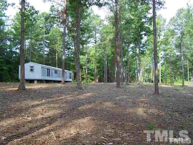 Lot 9 Rock Spring Church Road Henderson, NC 27537 - Photo 1 of 12 a view of a barn in the middle of a forest