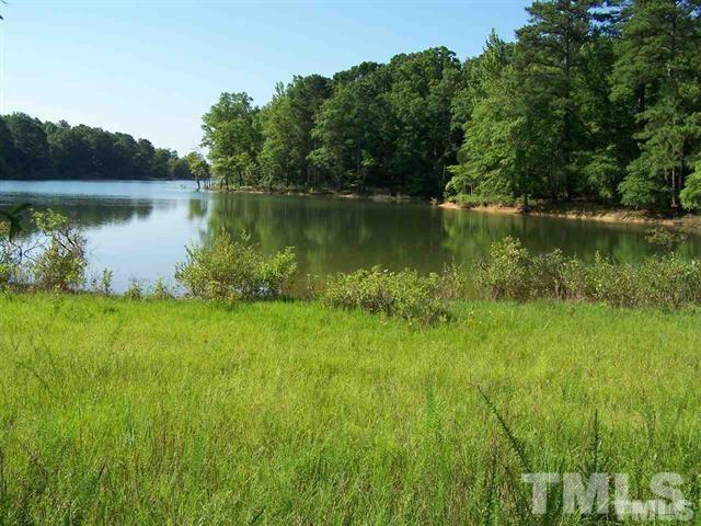 Lot 9 Rock Spring Church Road Henderson, NC 27537 - Photo 4 of 12 a view of a lake with a big yard and large trees