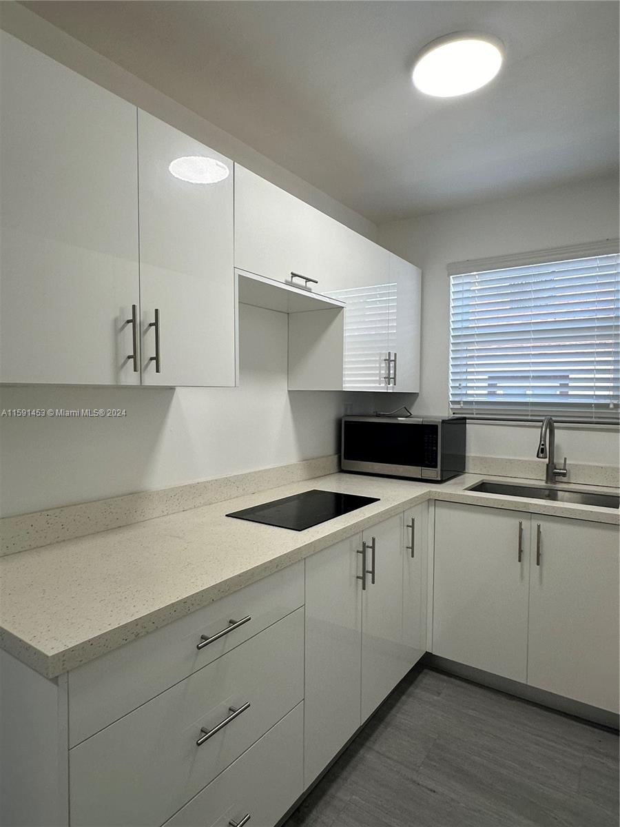 502 Southwest 27th Avenue, Unit 4 Miami, FL 33135 - Photo 5 of 11 a kitchen with a sink and cabinets
