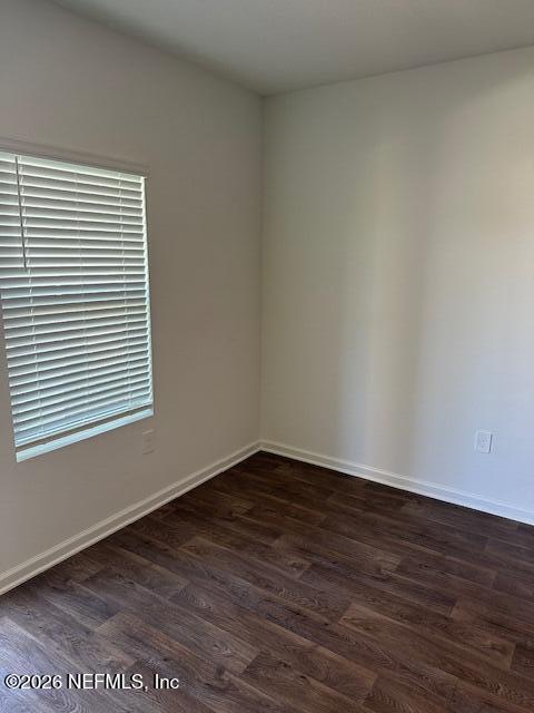 915 Rivertree Place Middleburg, FL 32068 - Photo 12 of 23 a view of an empty room with wooden floor and a window