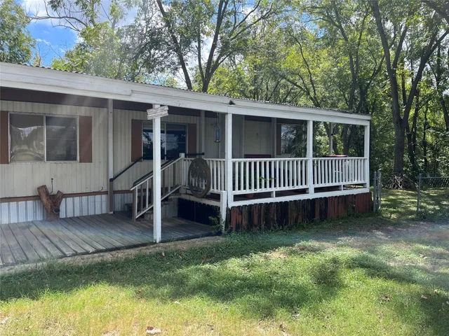 a view of a house with a yard and deck