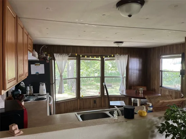 a living room with hardwood floor and a large window