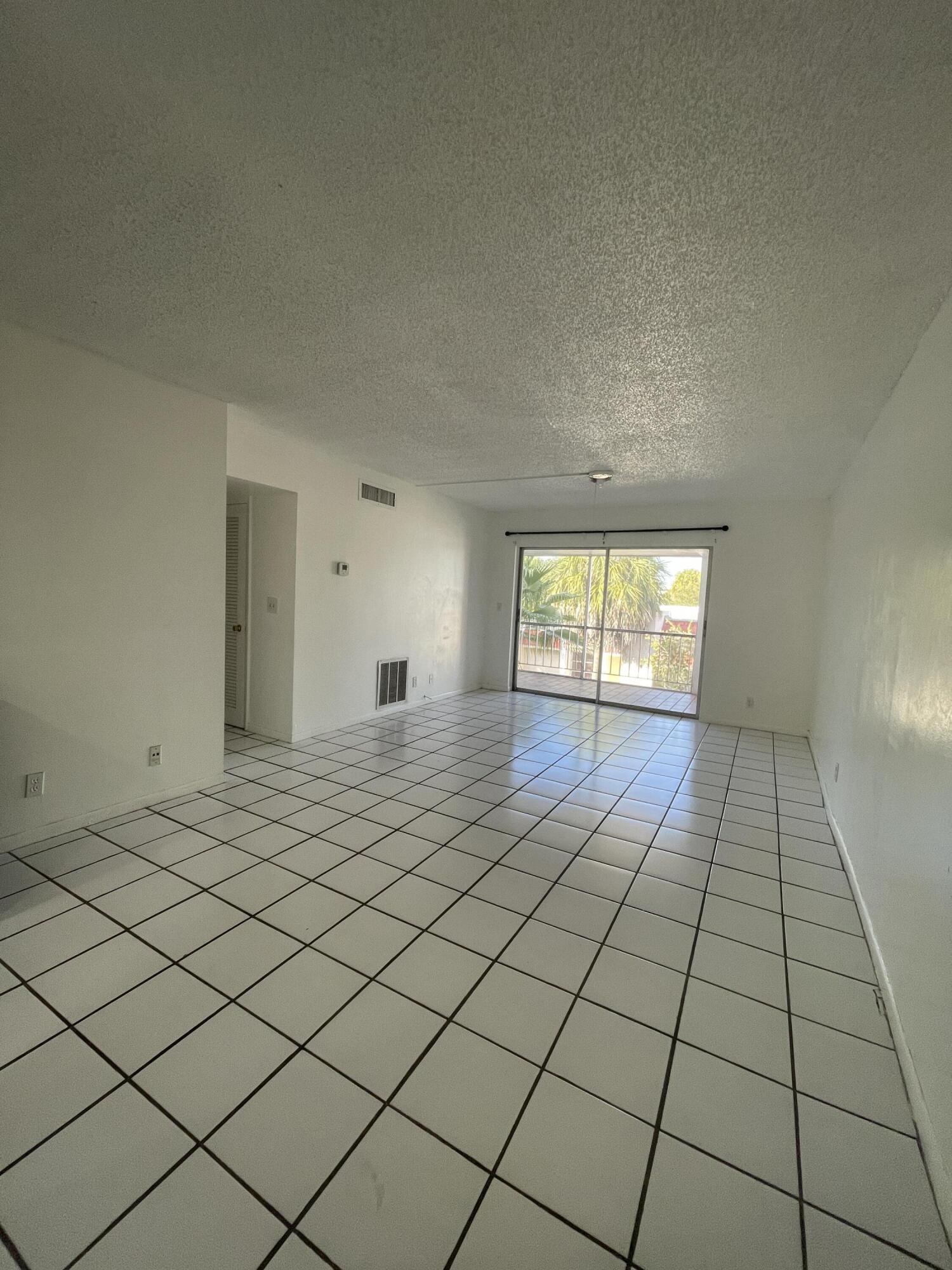 636 Northwest 13th Street, Unit 380 Boca Raton, FL 33486 - Photo 2 of 14 a view of an empty room and window