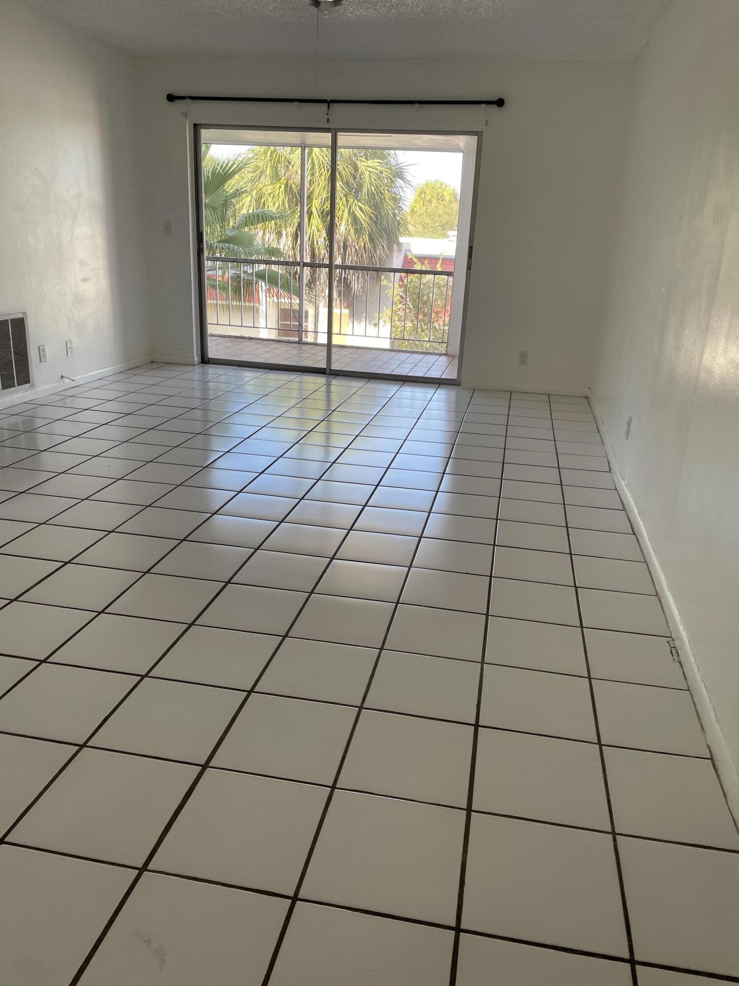 636 Northwest 13th Street, Unit 380 Boca Raton, FL 33486 - Photo 3 of 14 a view of empty room with windows