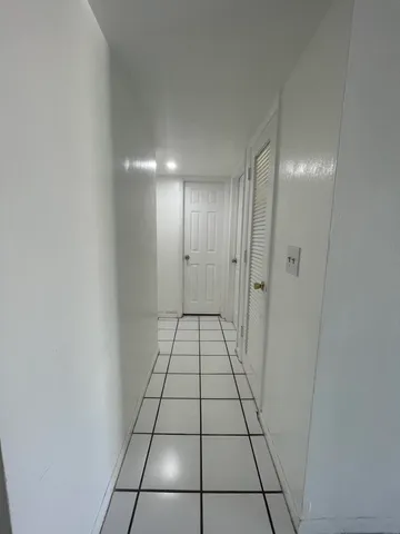 a view of an empty room and a bathroom