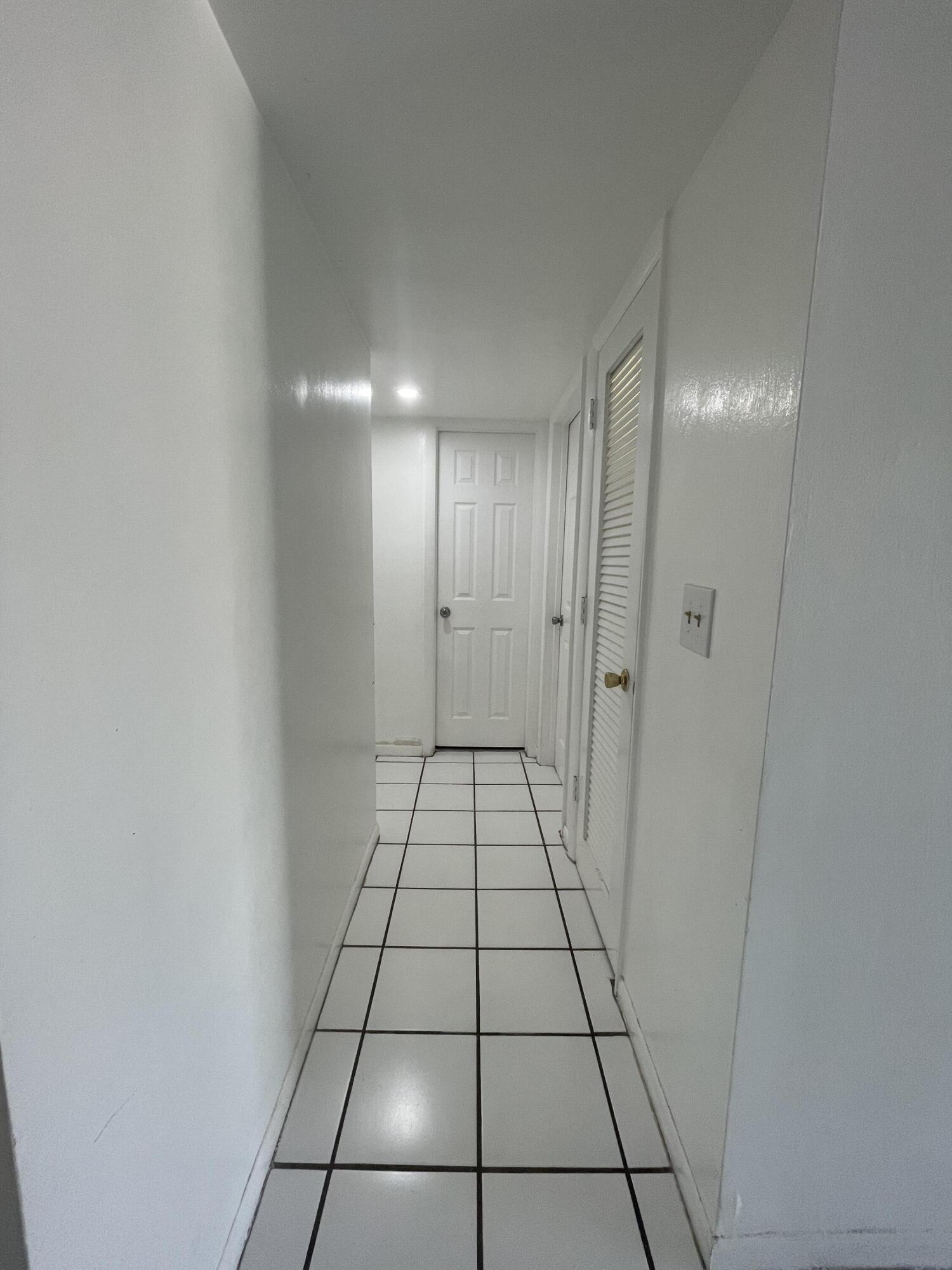 636 Northwest 13th Street, Unit 380 Boca Raton, FL 33486 - Photo 4 of 14 a view of an empty room and a bathroom