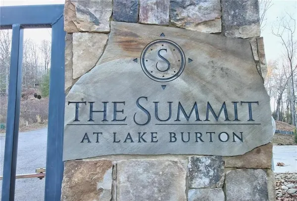 a street sign on a wall next to a road