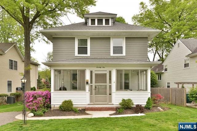 a front view of a house with a yard and porch
