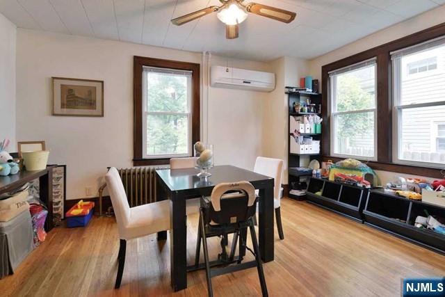71 Everett Street Closter, NJ 07624 - Photo 7 of 12 a dining room with furniture and wooden floor