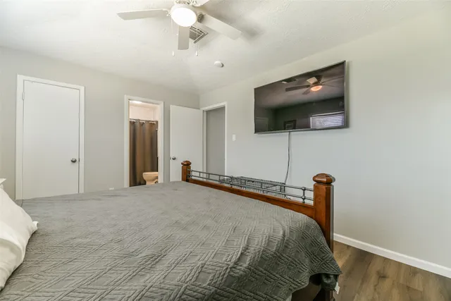 a bedroom with a bed and a flat screen tv