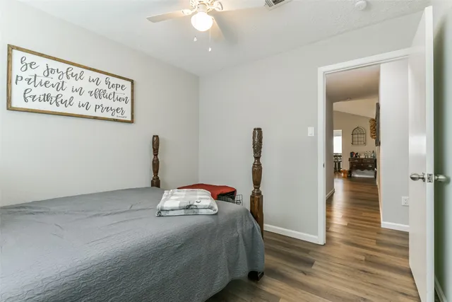 a bedroom with bed and a wooden floor