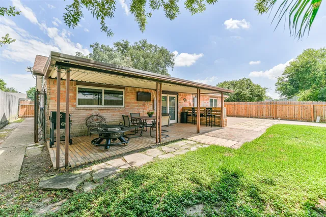 a view of backyard with a patio and outdoor seating